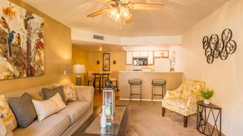 Arboretum living room with a couch, carpet and a ceiling fan